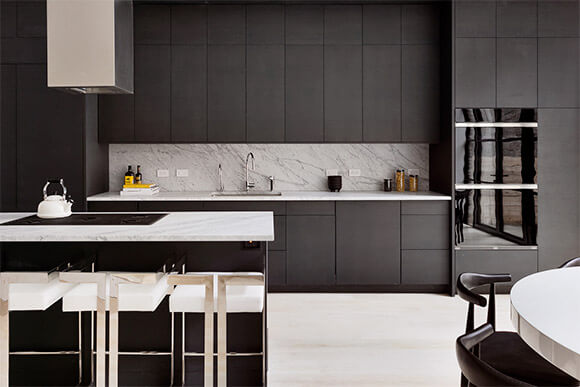 Cuisine au design minimaliste avec des armoires noires du sol jusqu'au plafond